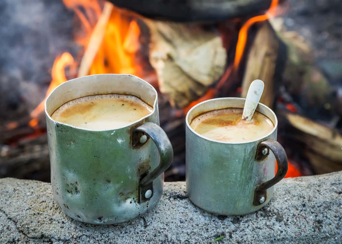 Process of making camping coffee outdoor with metal geyser Stock